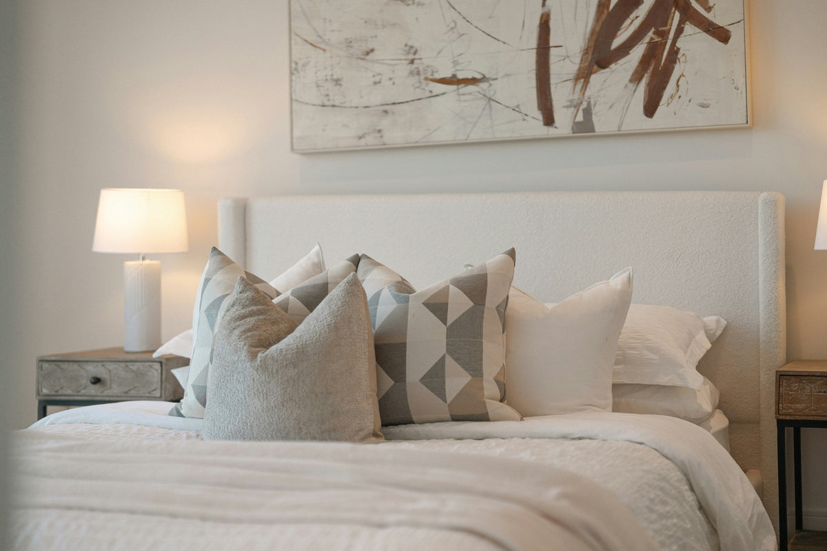 Freshly made bed with white linens and pillows